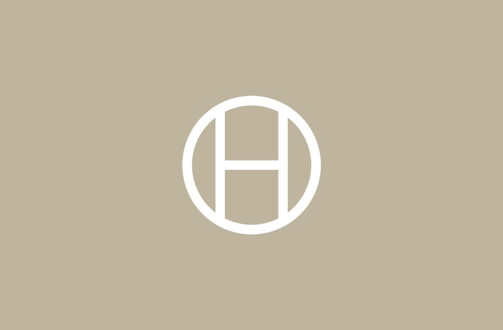 Opal Hospitality monogram on sand