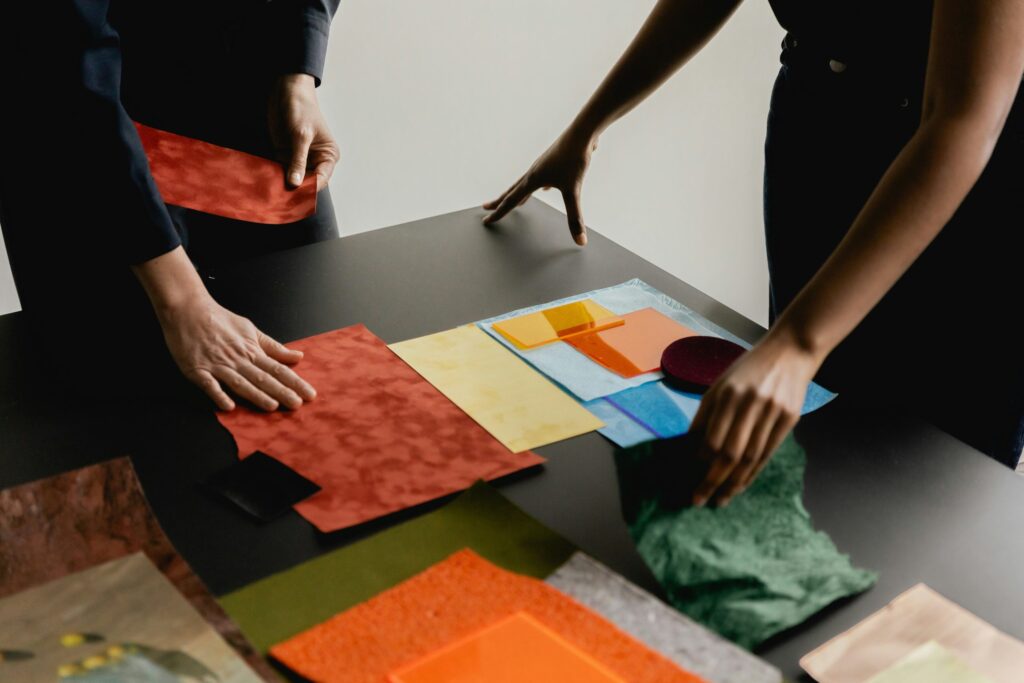 Hands arranging interior material swatches