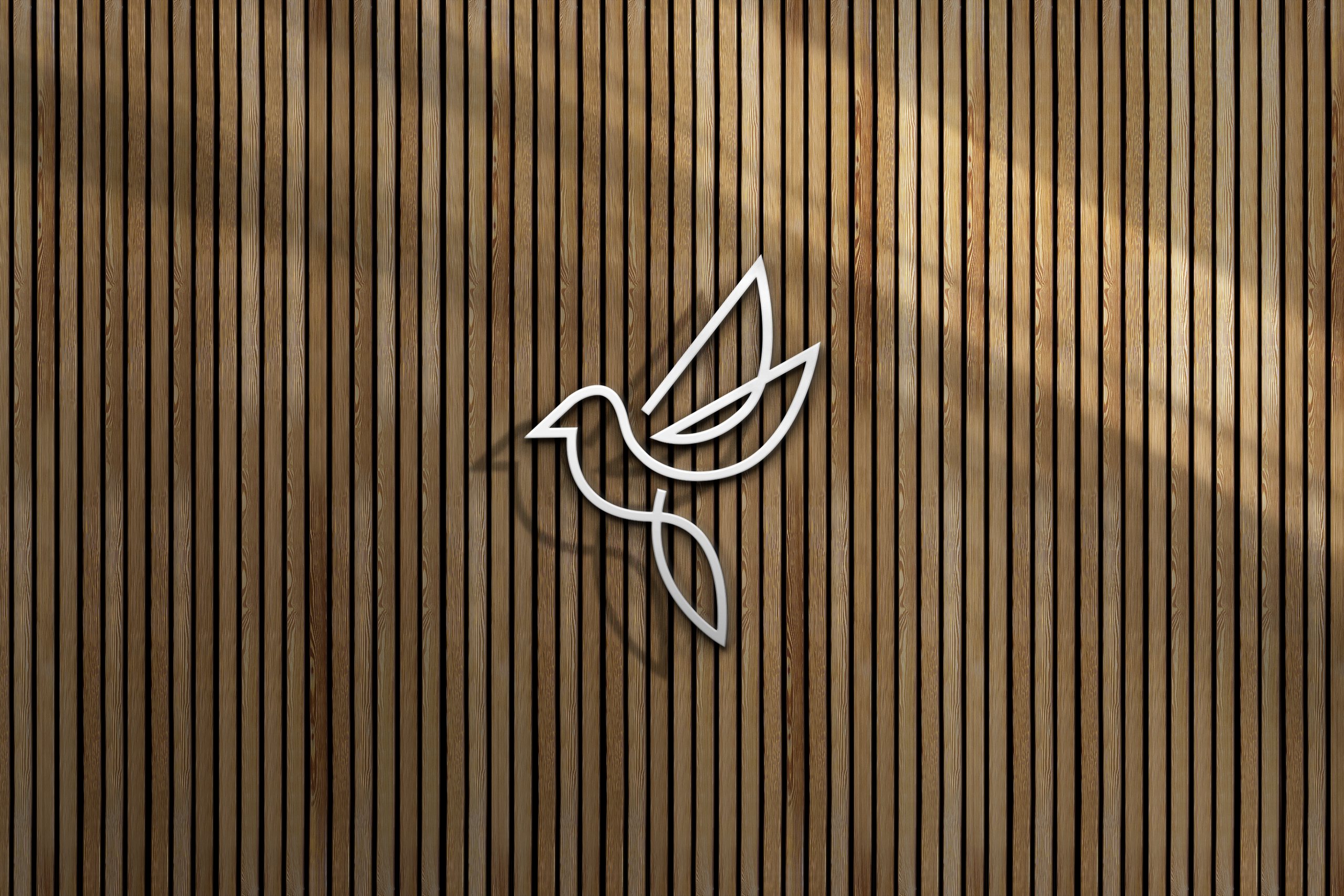 Woven Hotel bird logo on a timber slat wall